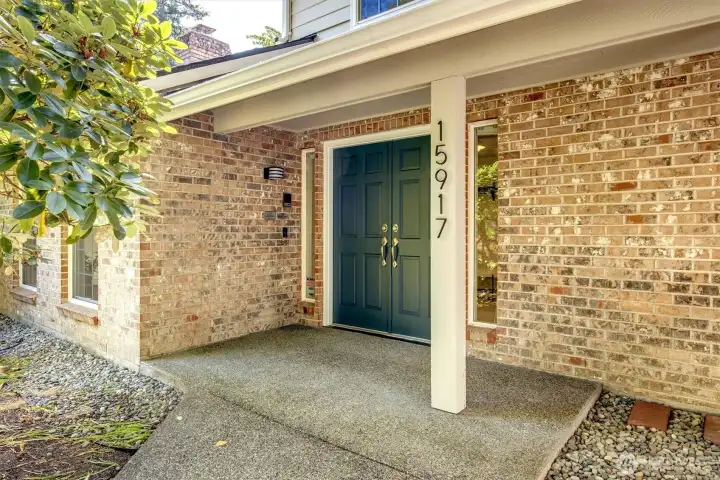 Double doors and no stairs at entry. This feature provides a seamless, accessible transition into the home, making it convenient for move-ins and ensuring ease of access for all guests. The wide entryway creates an inviting, spacious aesthetic while the level threshold eliminates common mobility barriers.