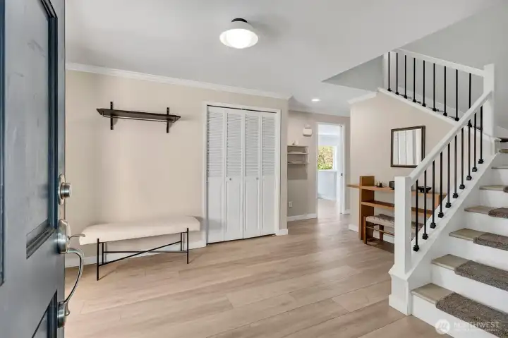 The entryway is remarkably spacious, providing ample room for the convenient removal of coats and footwear.