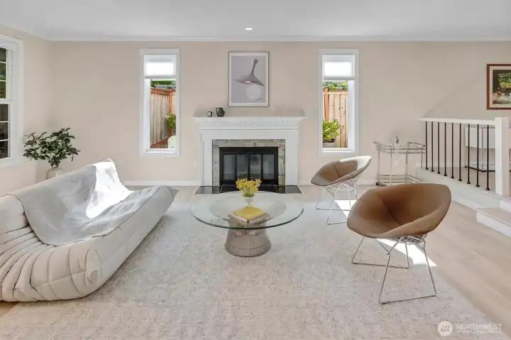 This formal living room serves as the heart of the home, featuring a stunning wood-burning fireplace that creates an inviting atmosphere perfect for hosting gatherings or enjoying quiet relaxation. With its warm, contemporary aesthetic and thoughtful design, this space offers a seamless blend of classic comfort and modern style, making it an ideal focal point for everyday living and memorable entertaining.