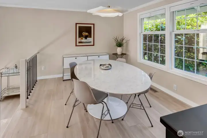 This dining room provides a spacious layout perfect for hosting, featuring ample room for an oversized dining table and additional cabinetry for storage or display. The open floor plan ensures seamless flow, making it an ideal space for both daily meals and formal gatherings.