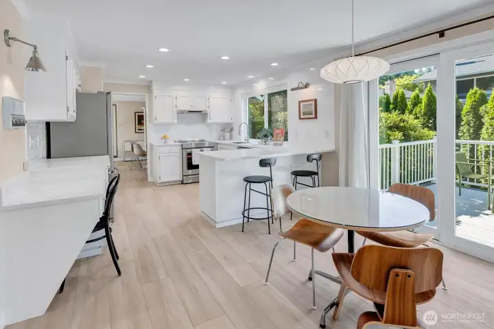 Wide-angle shot showing the full kitchen layout, including all cabinetry, appliances, peninsula and eating space.