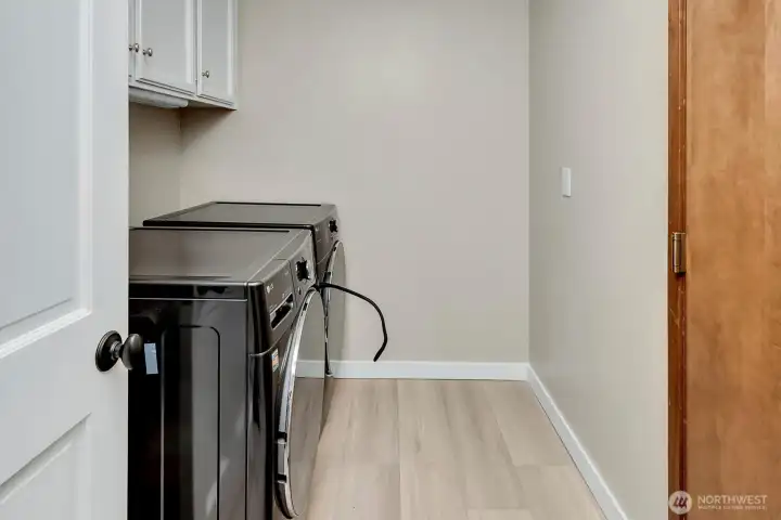 Laundry room features a washer and dryer that convey with the property.