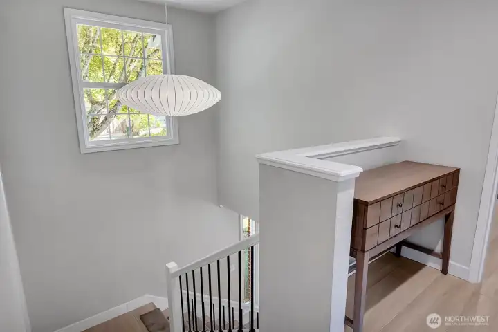 Stunning staircase featuring a Herman Miller light fixture.