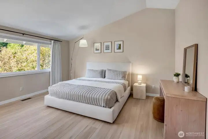 Beautifully renovated primary suite featuring expansive windows that invite abundant natural light.