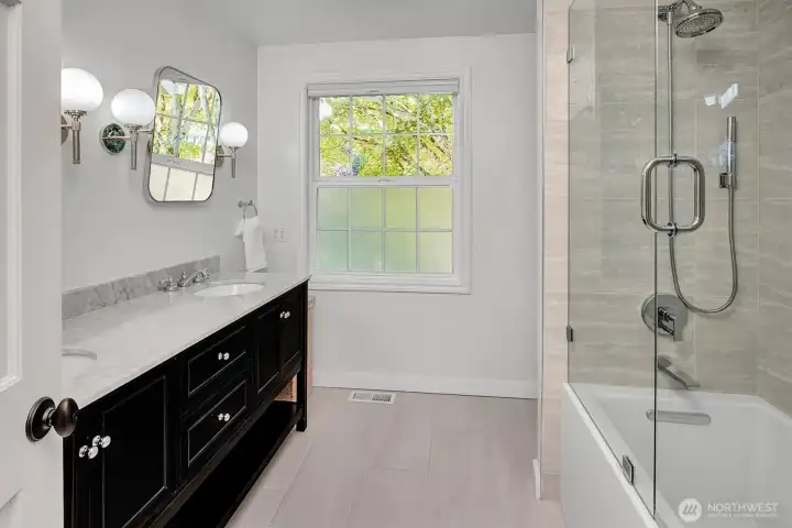 Main bathroom, Level 2, featuring a full bathtub and high-quality finishes. This serene space offers a relaxing retreat with modern fixtures, ample vanity storage, and optimal lighting,