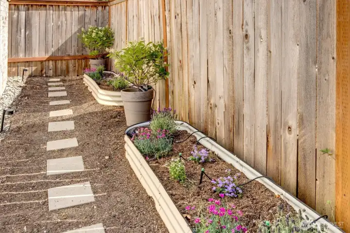 Beautifully landscaped side garden featuring a variety of vibrant, seasonal flowers.