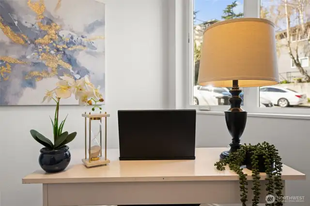 Lower Level- Office, den or extra bedroom (does not have closet, but could be a third bedroom) with beautiful engineered hardwood floors, lots of natural light, beautiful flower garden right outside window; perfect for work from home or relaxing while gaming