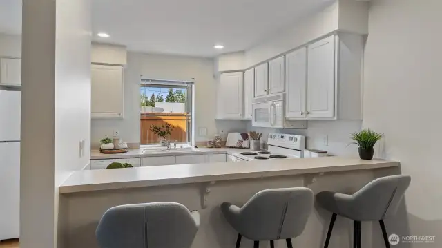Convenient breakfast bar provides additional dining space.