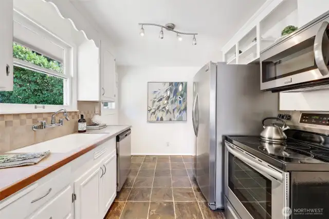 All Frigidaire Gallery appliances and tile floor. Window looking to back yard.