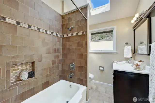 The skylight fills the full bath with natural light!