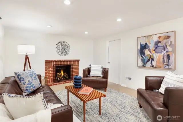 Lower level rec/living room with all new carpet and wood burning fireplace.