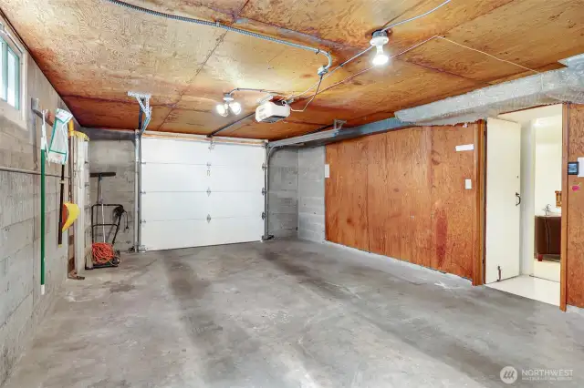 Wide and long one-car garage for bigger vehicles and space for storage and the workbench (behind this view)