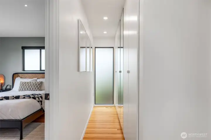 The Primary suite has it ALL! Wall of closets and light separates the ensuite bath from the bedroom.