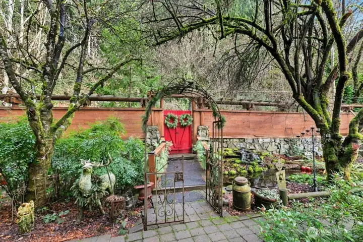 Lovely view to Koi pond/bridge and gated entrance from front door of the home