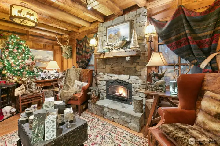 Famiy Room with stunning stone fireplace and reclaimed wood mantle, custom lighting and that beautiful log construction. (This area is currently part of the Active Business/shop)