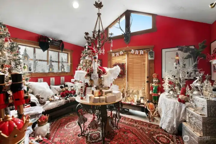 Living room with vaulted ceilings (used as part of Christmas Shop business currently)