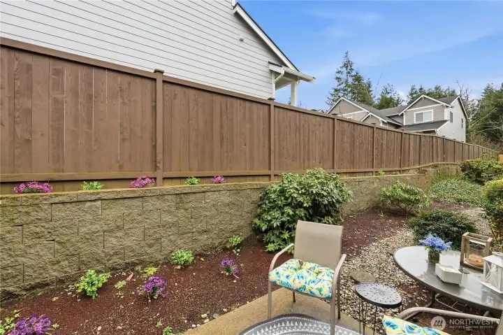 Private yard gets the afternoon sunshine.  Evergreen shrubs for year around greenery, the Rhododendron flowers beautifully in April/May.