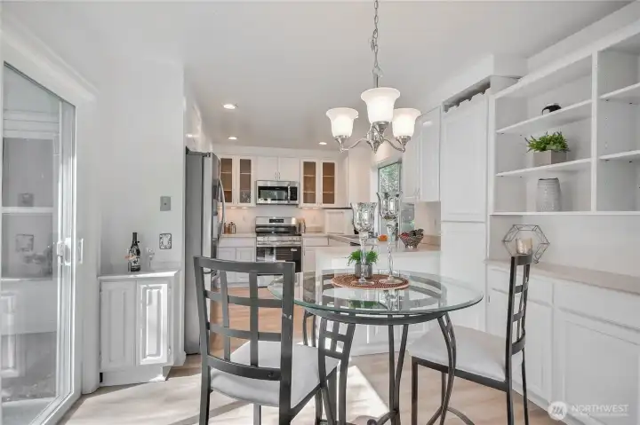 Enjoy morning coffee in this cute nook! Slider to patio.