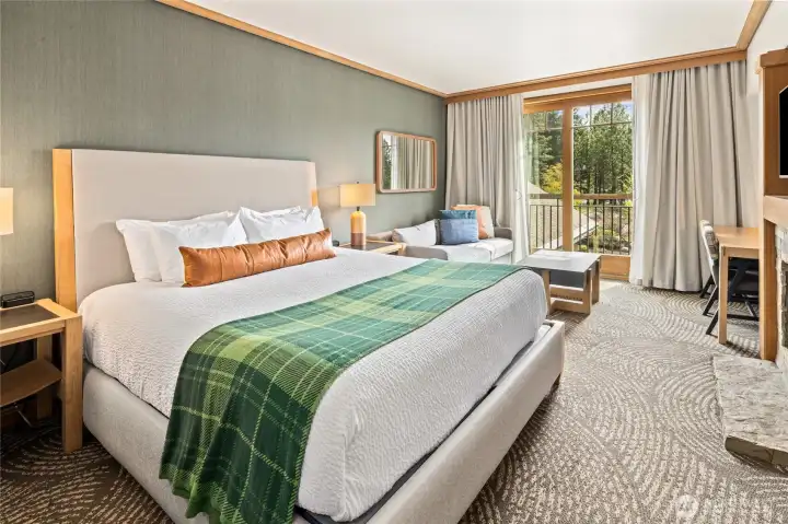 Open-concept studio with cozy fireplace and inviting seating area.