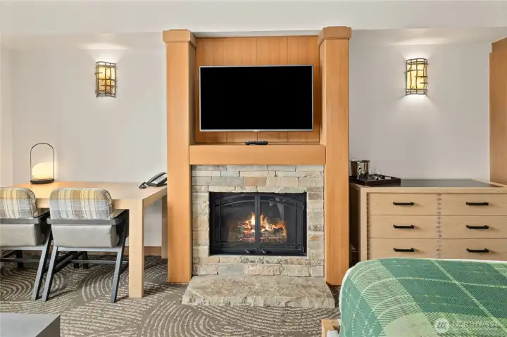 Stone gas fireplace creates a warm, lodge-inspired focal point.