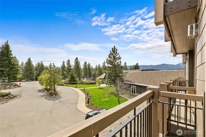 Private balcony facing east with peaceful views of surrounding evergreens.