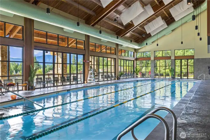 Expansive indoor pool area with soaring wood-beamed ceilings.