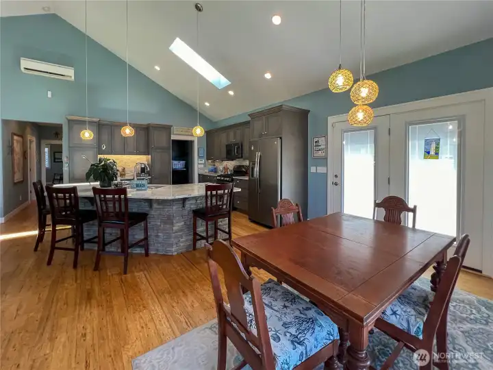 The spacious great room with vaulted ceiling makes for a light bright feeling and is sure to please. The floors are beautiful eucalyptus wood and the center island is stacked stone accented.