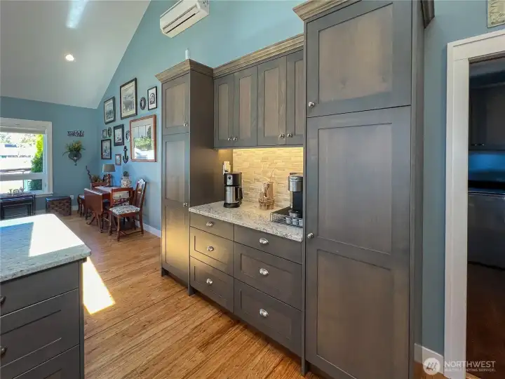 Coffee bar and pantry cabinets and drawers for additional storage.