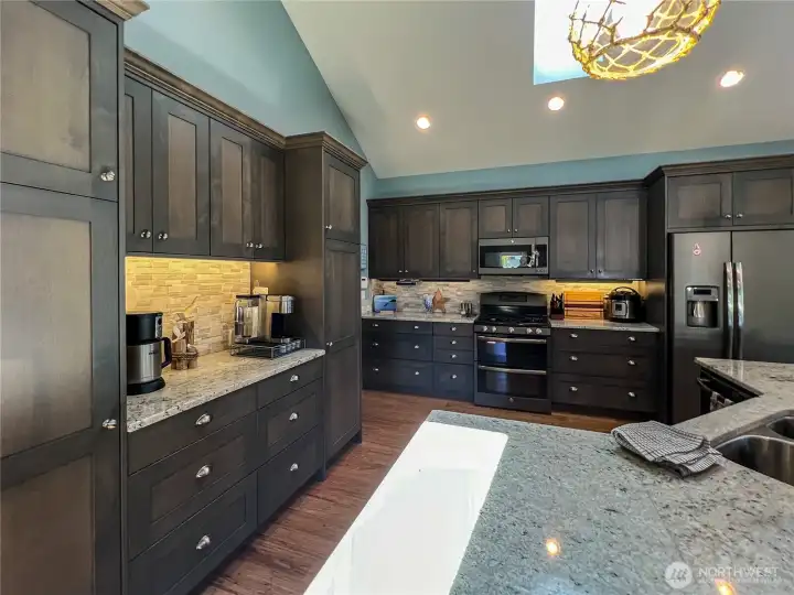 Additional shot of gourmet kitchen with granite counters, ample cabinets and drawers. There is room for everything in this beauty.