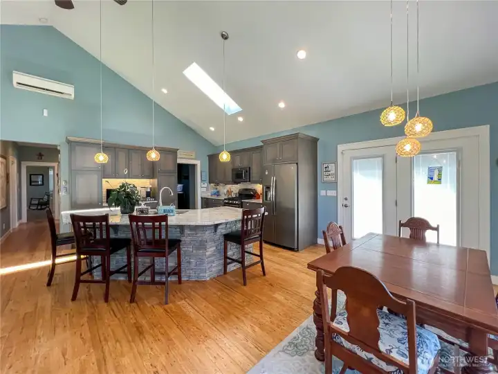 Additional view of kitchen showing the entry door, view of  hallway to bedrooms and doorway to utility room.