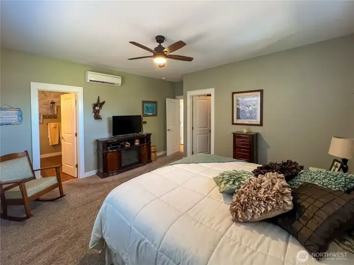 Another view of primary bedroom showing access to primary bath and walk in closet.