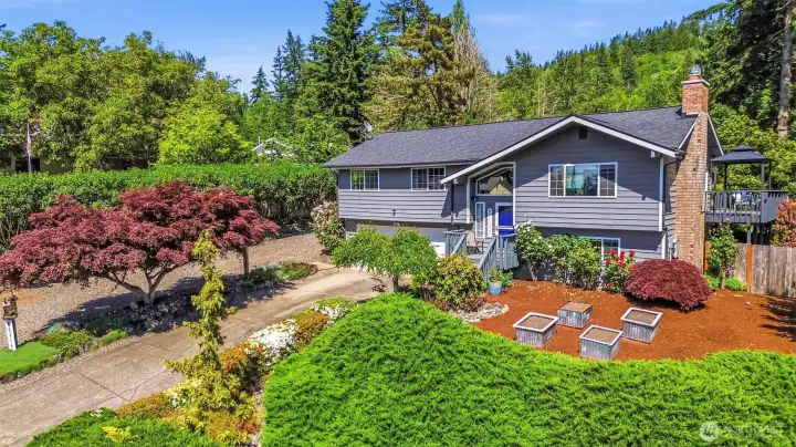 Beautifully maintained Fairway Hills home in Enumclaw featuring a large .44-acre lot, RV parking, shop, mature landscaping, and exceptional curb appeal on a quiet dead-end street.