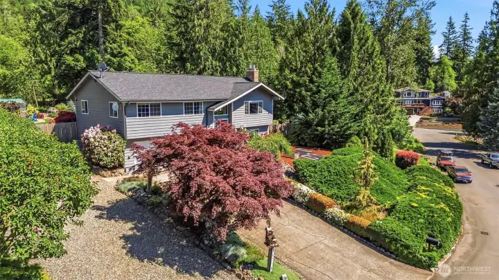 Aerial view showcasing the oversized 19,165 sq ft lot, established landscaping, RV parking, detached small shop, and desirable Fairway Hills location in Enumclaw.
