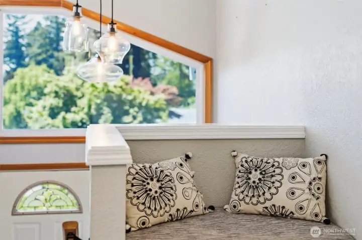 Bright entryway filled with natural light and large windows creating a warm and welcoming first impression.