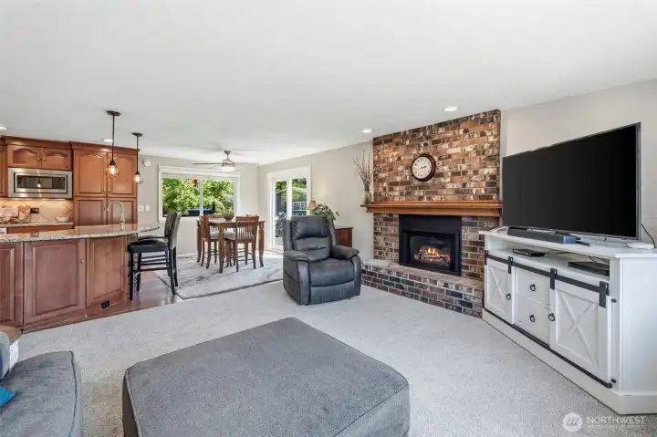 Spacious upper-level living room featuring a gas fireplace, flexible living space, and plenty of room for entertaining or relaxing.