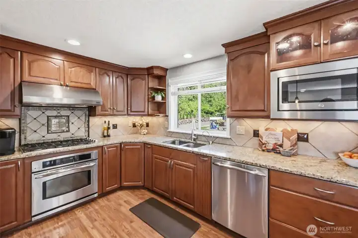 Well-appointed kitchen with rich cabinetry, stainless steel appliances, ample counter space, and excellent functionality for daily living.