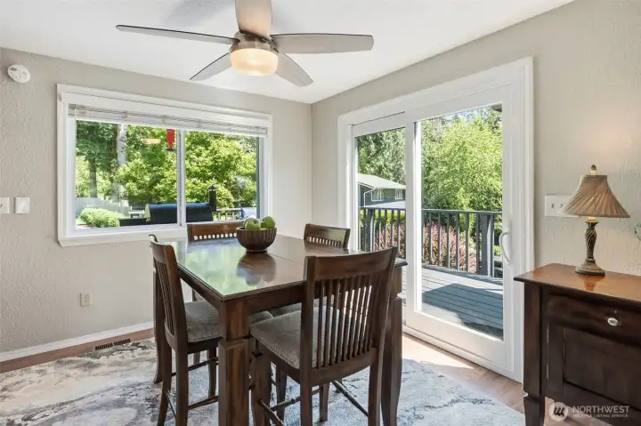 Dining area surrounded by windows and natural light, offering the perfect setting for meals while overlooking the private backyard.