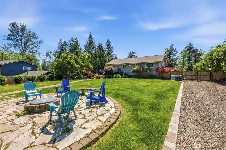 Large backyard patio with fire pit area offers the perfect place to relax, entertain, and enjoy Enumclaw evenings.
