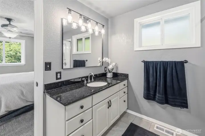 Updated bathroom with oversized vanity, modern fixtures, and plenty of storage for everyday functionality.