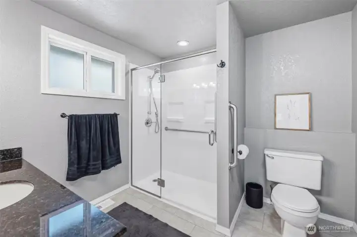 Well-maintained bathroom featuring a walk-in shower, bright finishes, and comfortable everyday living.