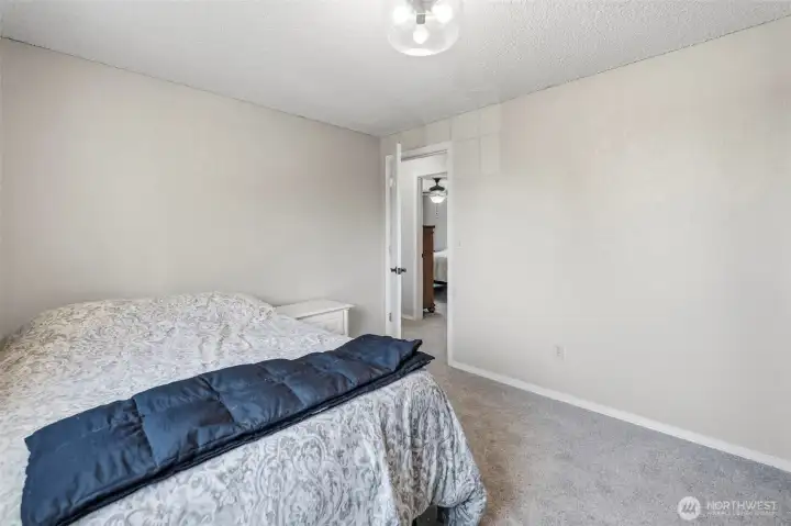 Secondary bedroom with neutral finishes, abundant natural light, and flexible space for guests, family, or a dedicated home office.