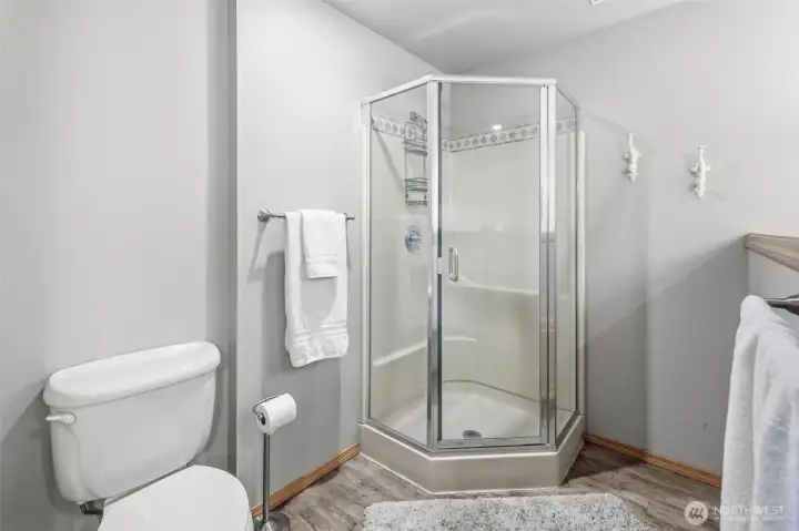 Updated bath with walk-in shower, modern fixtures, and functional design for everyday comfort.
