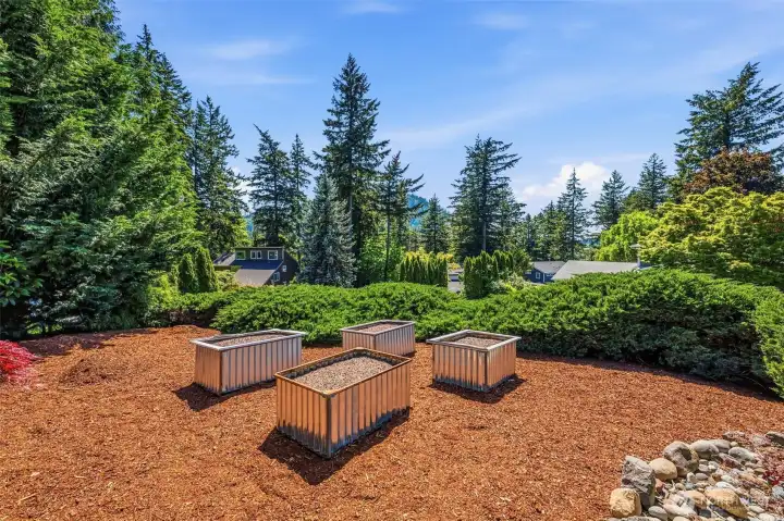 Raised Garden beds  surrounded by mature landscaping and privacy, creating a peaceful retreat to enjoy year-round.