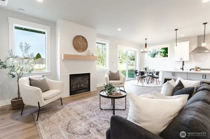 Welcome to this beautiful new construction home where a cozy gas fireplace with shiplap surround anchors the living room, while big windows and a slider frame peaceful greenspace views.