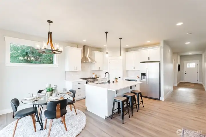 The light-filled kitchen and dining area at the heart of the home, just off the entry and open to the living room for easy everyday flow.