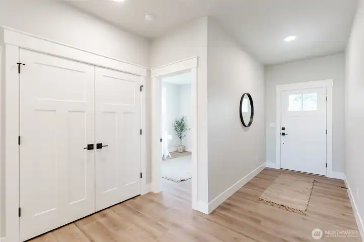Enter into the bright foyer with durable LVP flooring and a large coat/storage closet to keep everyday items neatly tucked away.