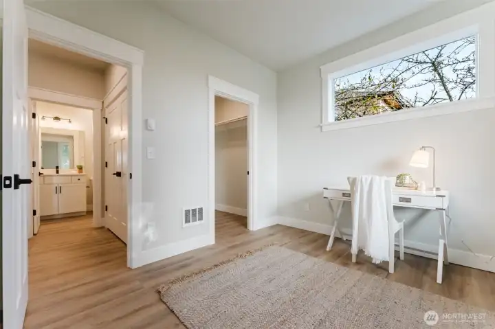 At the front of the home you'll find a flexible main-floor office/bedroom with a walk-in closet and nearby bath—perfect for guests, work, or multigenerational living.