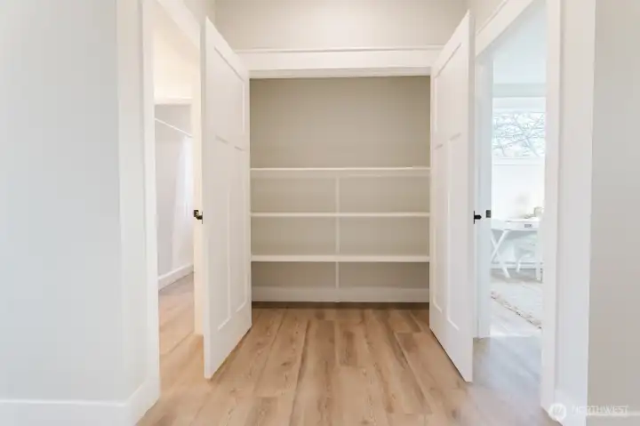 Bonus storage closet with built-in shelving adds to the home’s generous closet space.