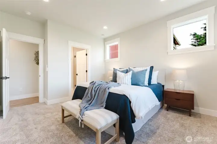 The primary bedroom with direct access to the ensuite and a large walk-in closet, all on the main level.