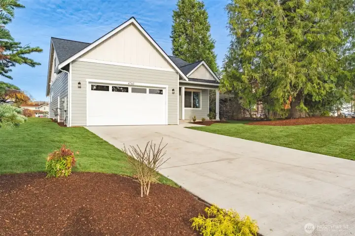 An extra-long driveway and attached garage, offering ample off-street parking for cars, guests, or toys.